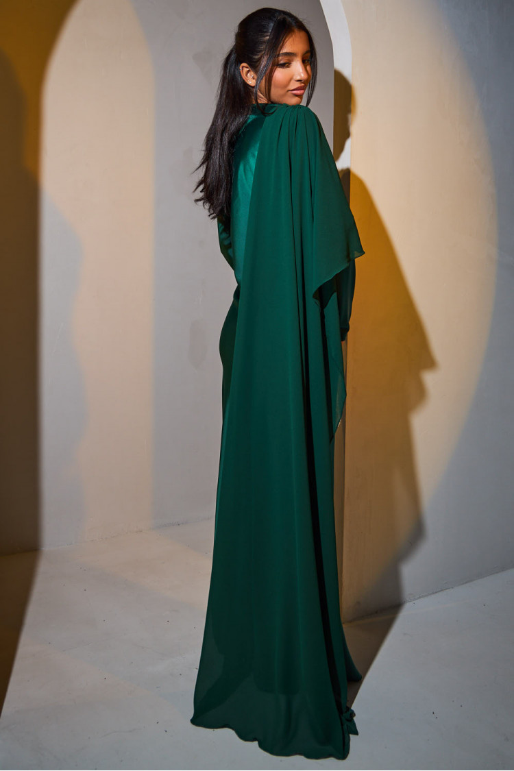 Green satin dress draped on the top