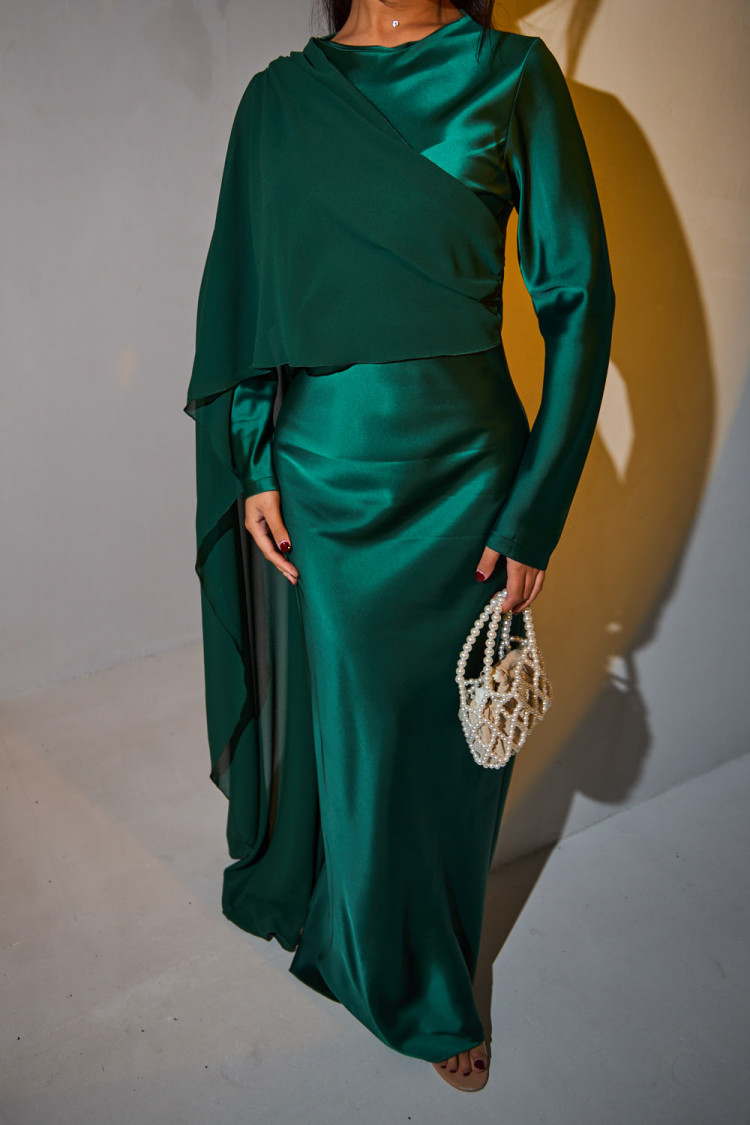 Green satin dress draped on the top